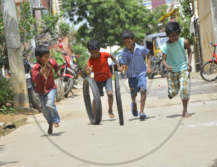 Indian Children playing Tyre Rolling Game on Streets