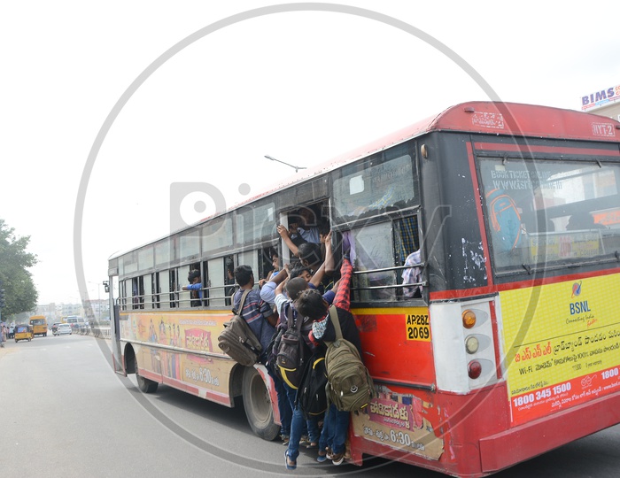 Foot board Travelling In a City Bus By College Students