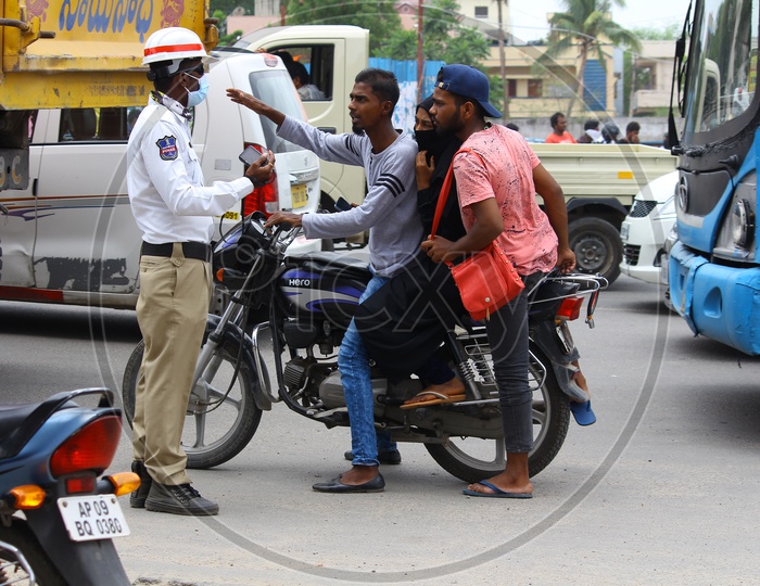 Traffic Police Stopping Triple Riding Bike Commuter Without Helmet on Hyderabad City Roads