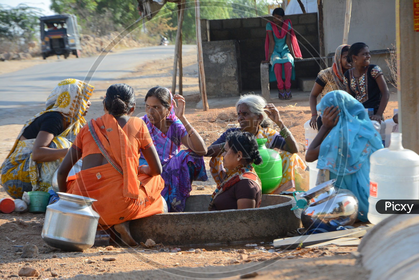 Indian Woman With Water Carrying Vessels At a drinking Water Pipeline in Water Crisis Areas of Hyderabad