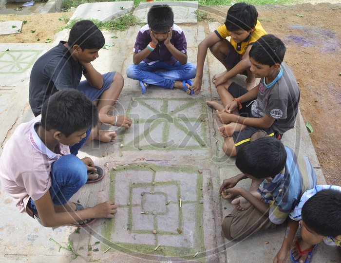 Young Children Playing Board Games In Rural Indian Villages