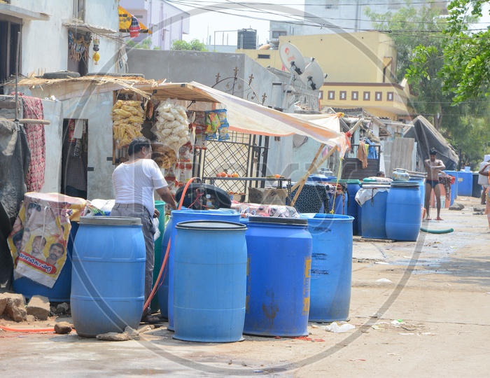 A Man Filling the Plastic Drums With Drinking Water For Storage At Water Crisis Areas of Hyderabad