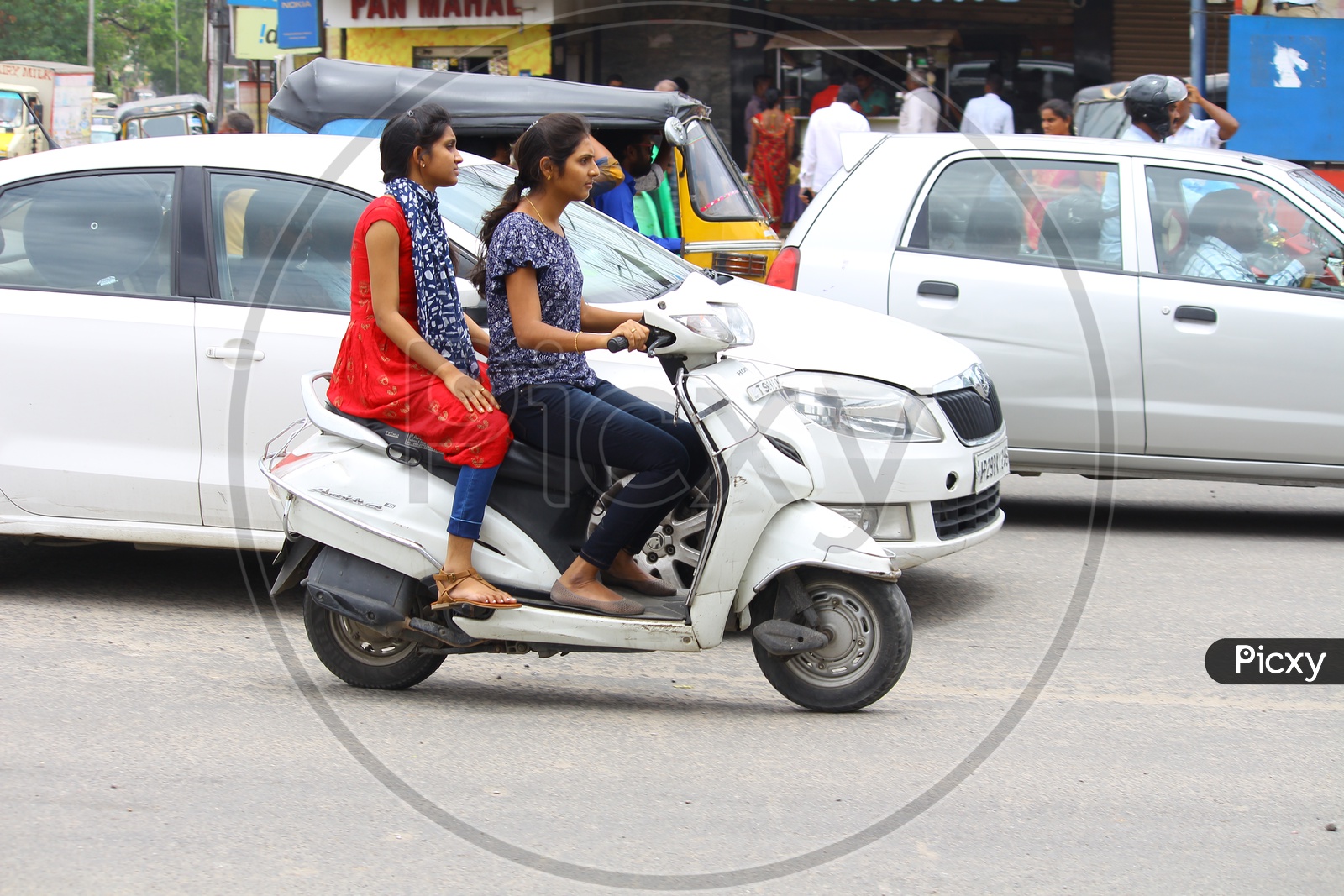 Young Indian Girls Riding Scooty Without Helmet Violating Traffic Rules