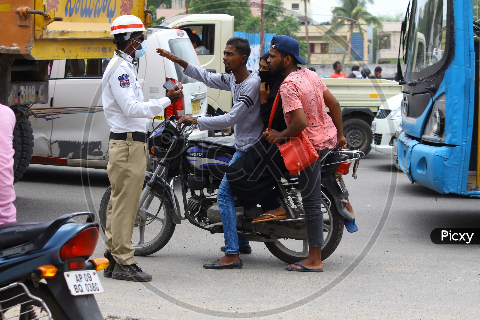 Traffic Police Stopping Triple Riding Bike Commuter Without Helmet on Hyderabad City Roads