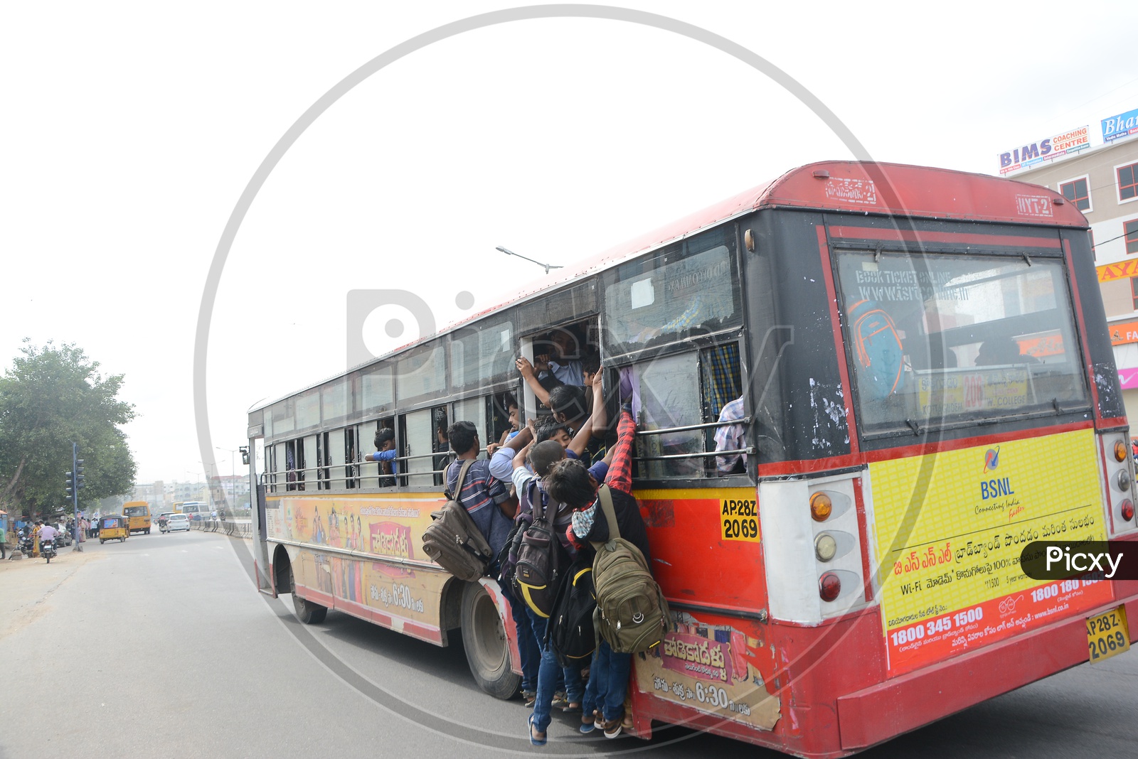 Foot board Travelling In a City Bus By College Students