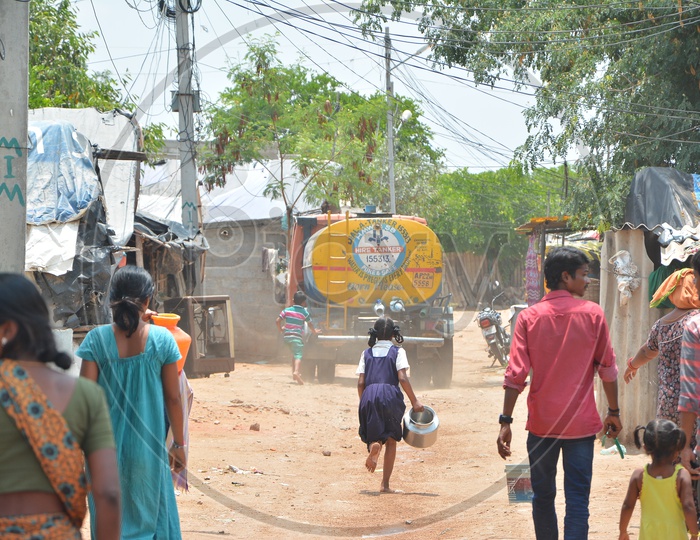 Children Running towards A Water Tank For Drinking Water At Water Crisis Areas in 
 Hyderabad