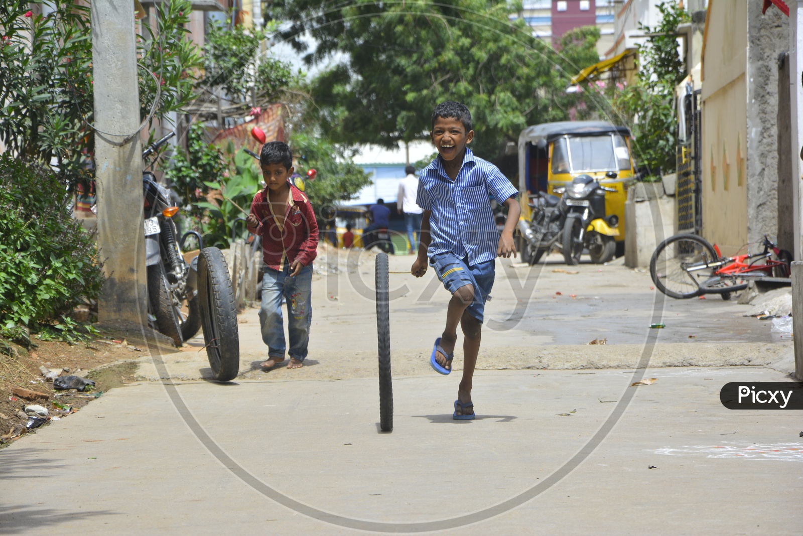 Indian Children playing Tyre Rolling Game on Streets