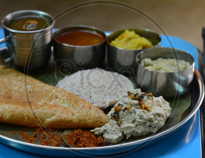 Indian Breakfast With Idly, Dosa , Kichadi and Pongal Served As a Combo In a Plate