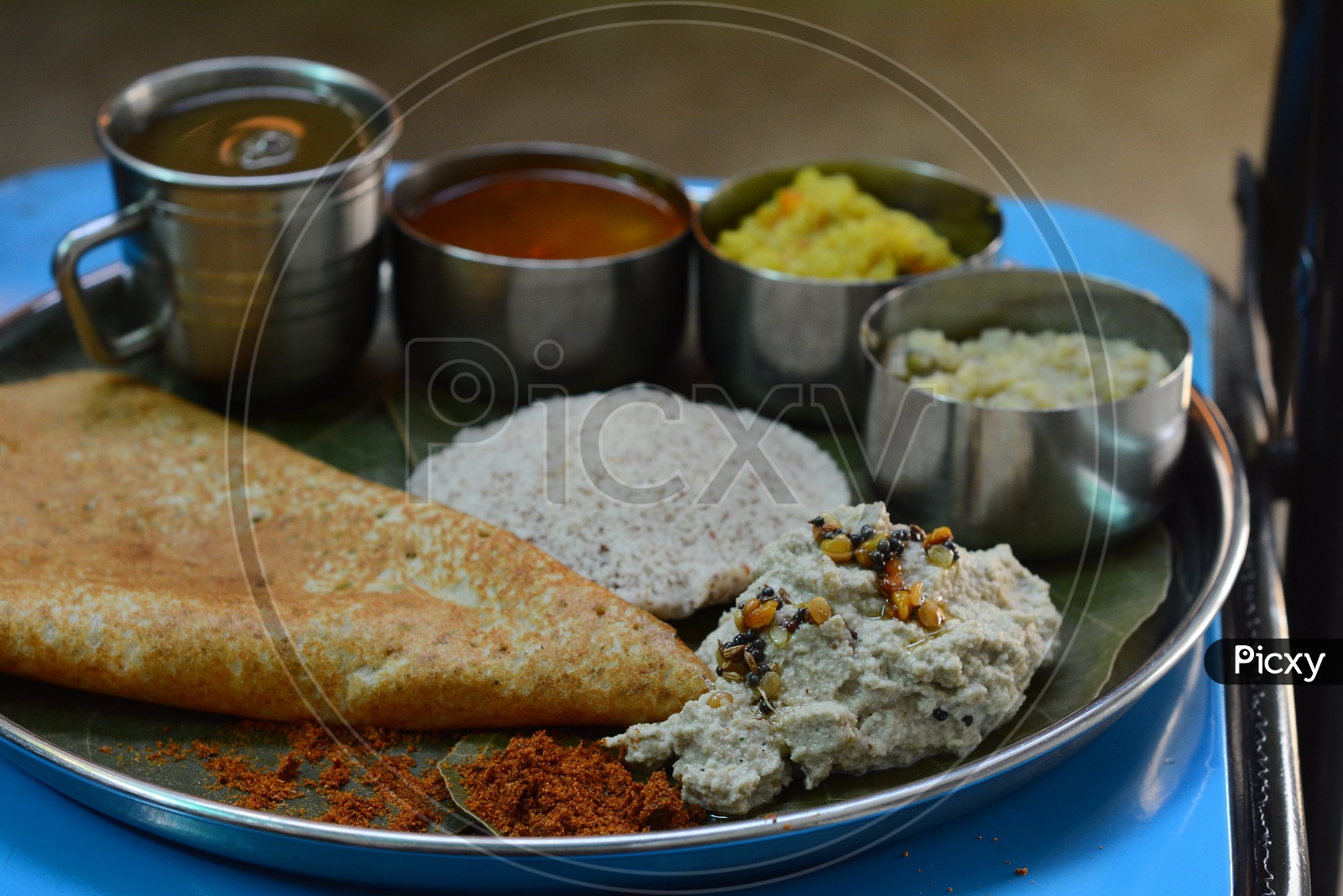 Indian Breakfast With Idly, Dosa , Kichadi and Pongal Served As a Combo In a Plate