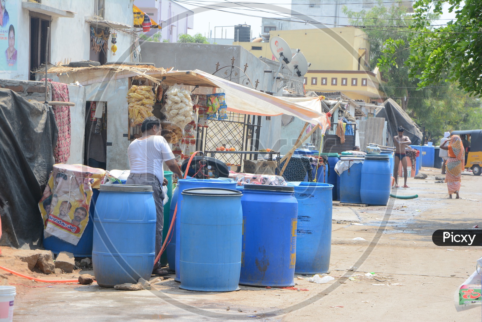 A Man Filling the Plastic Drums With Drinking Water For Storage At Water Crisis Areas of Hyderabad