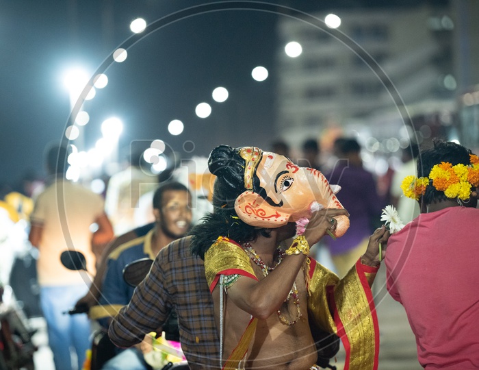 Artist Wearing Lord Ganesh Mask During Ganesh Idol Immersion Event at Tank Bund