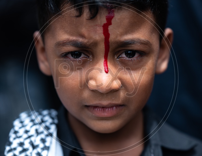 Portrait Of a Young  Boy Bleeding With Knife cut On Head During Muharram Mournings