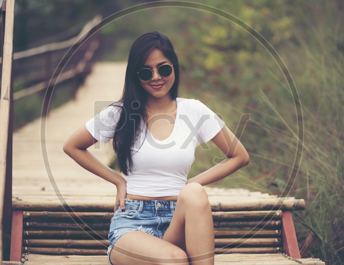 Portrait of pretty young  Asian woman standing outdoors And  smile and happy