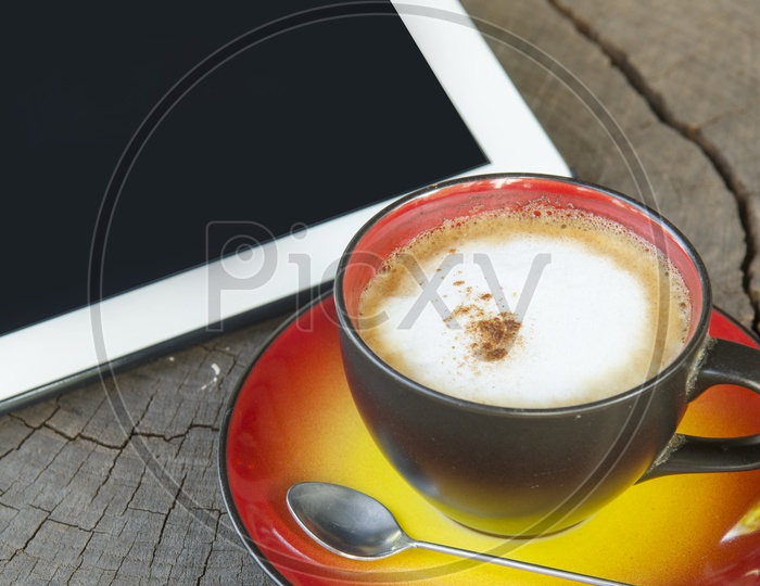 digital tablet and coffee cup on wooden table