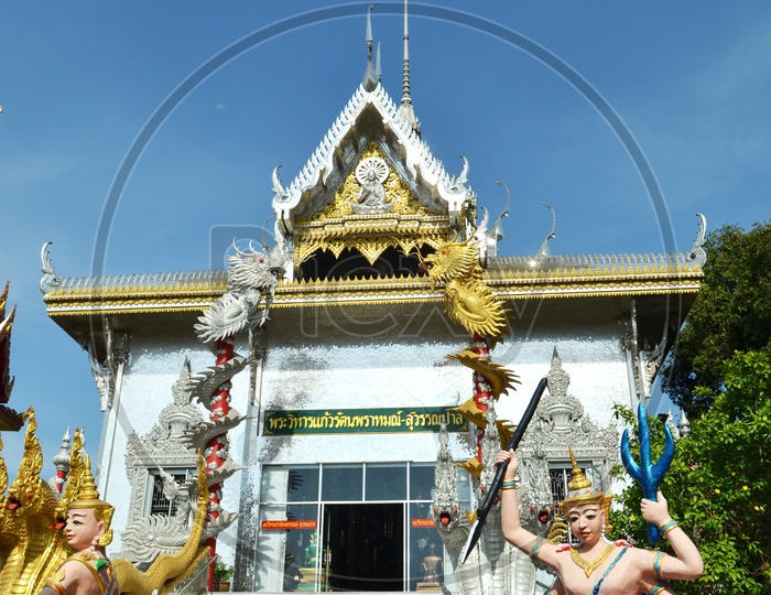 Thai Temple With Shrine Over  Blue Sky