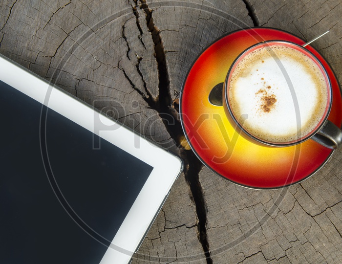 Digital Tablet Pc With Coffee Cup on Wooden table