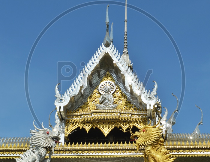 Thai Temple With Shrine Over  Blue Sky