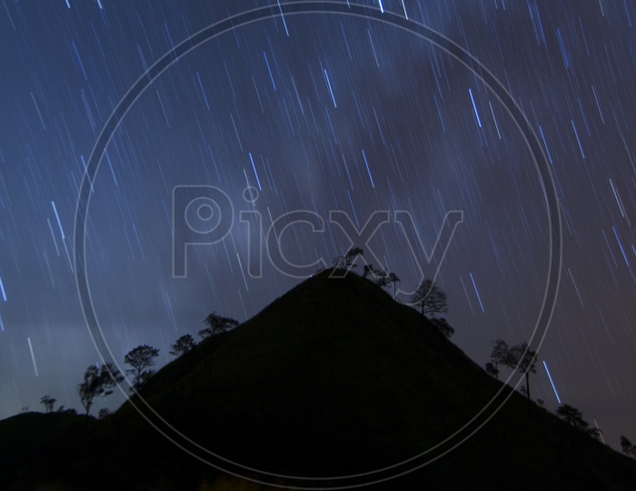 Star Trails With Galaxy or Milkyway Stars  over Mountain in  Khao chang puak, Thailand