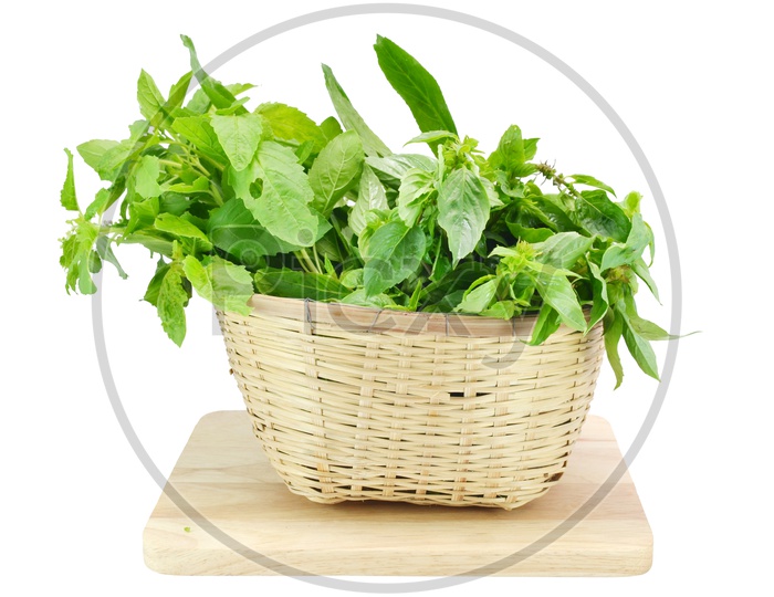 Fresh Green Leafy Vegetables On Basket  On an Isolated White Background