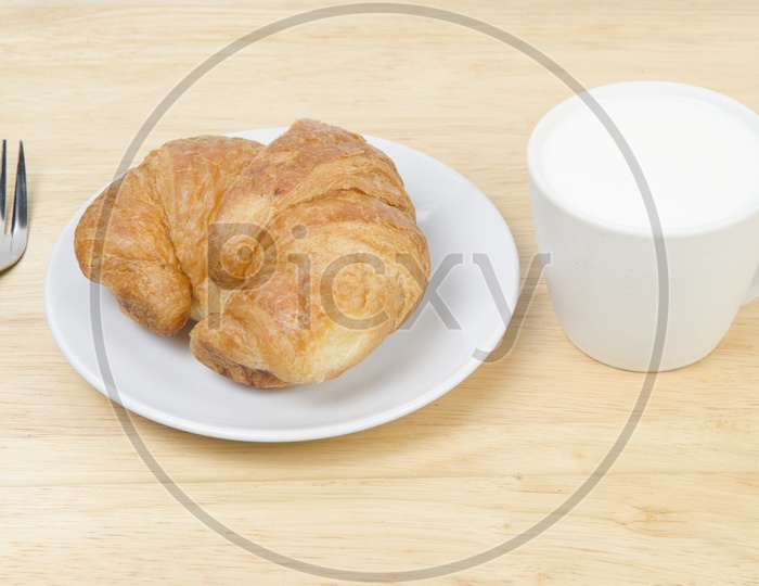 glass of milk and Croissants bread