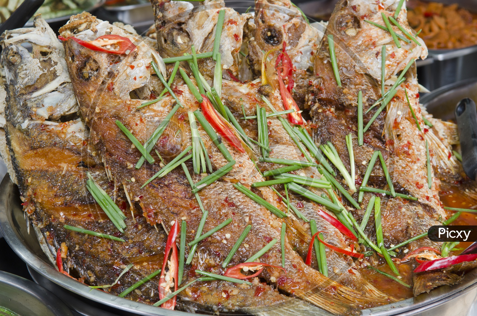 Freshly prepared Thai style whole fish red snapper dinner with tamarind sauce In a Traditional Thai Restaurant