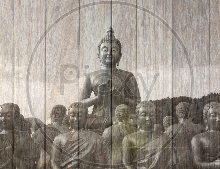 Double Exposure Of Buddha Statues  Over  wooden board