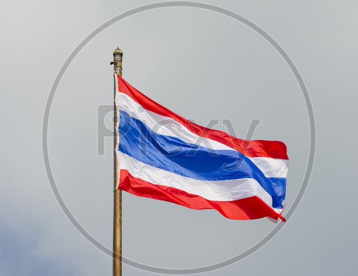 Thai Flag Waving On a Flag Pole Over Sky Background