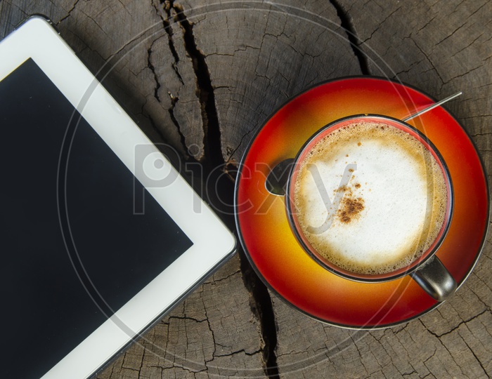 Digital Tablet Pc With Coffee Cup on Wooden table