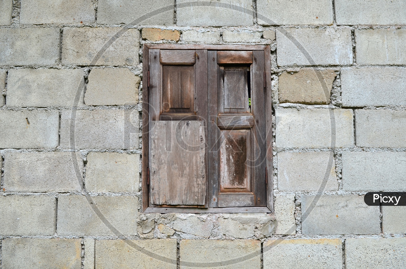 Traditional Wooden Window Over a Stone Wall