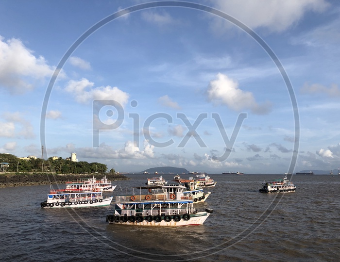 Tourist Boats in the Sea with Clouds in Sky Background