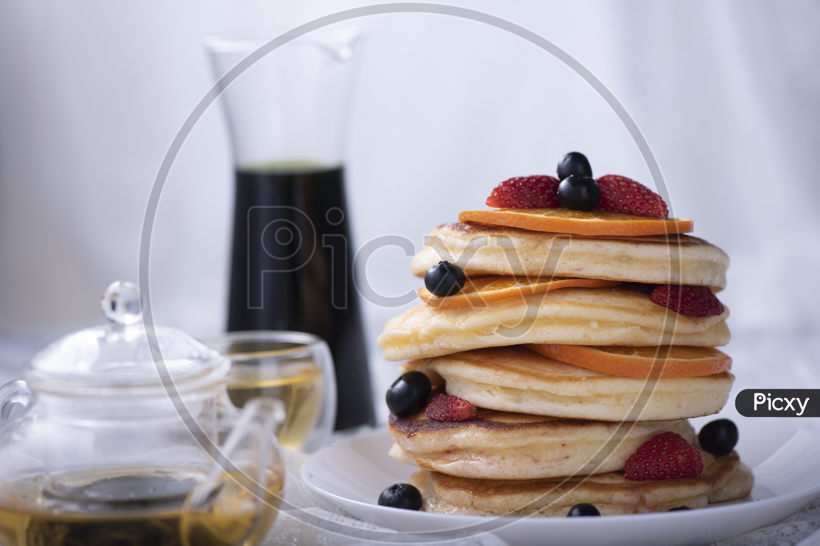 pancake stack with strawberry, blueberry, and orange