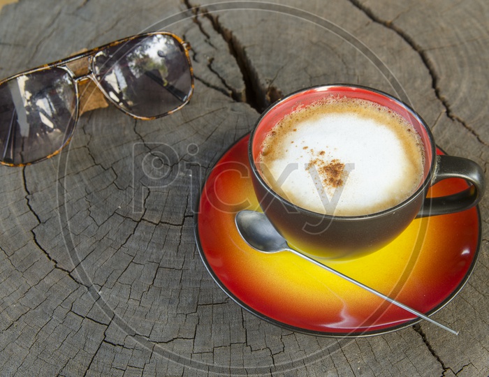 Coffee Cup And Sunglasses On Wooden Table Background