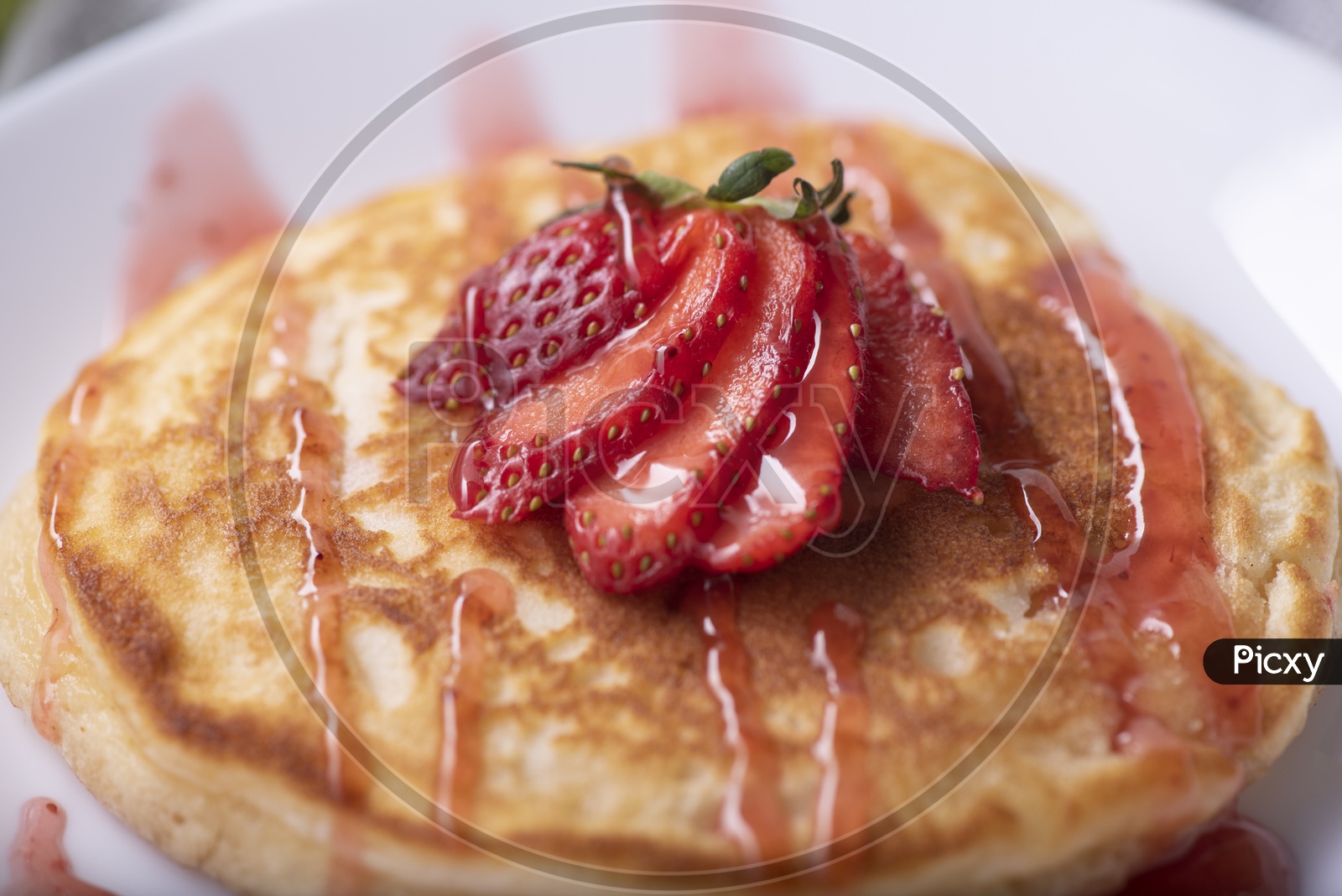 Homemade Pancake with Strawberry and Honey in a Plate