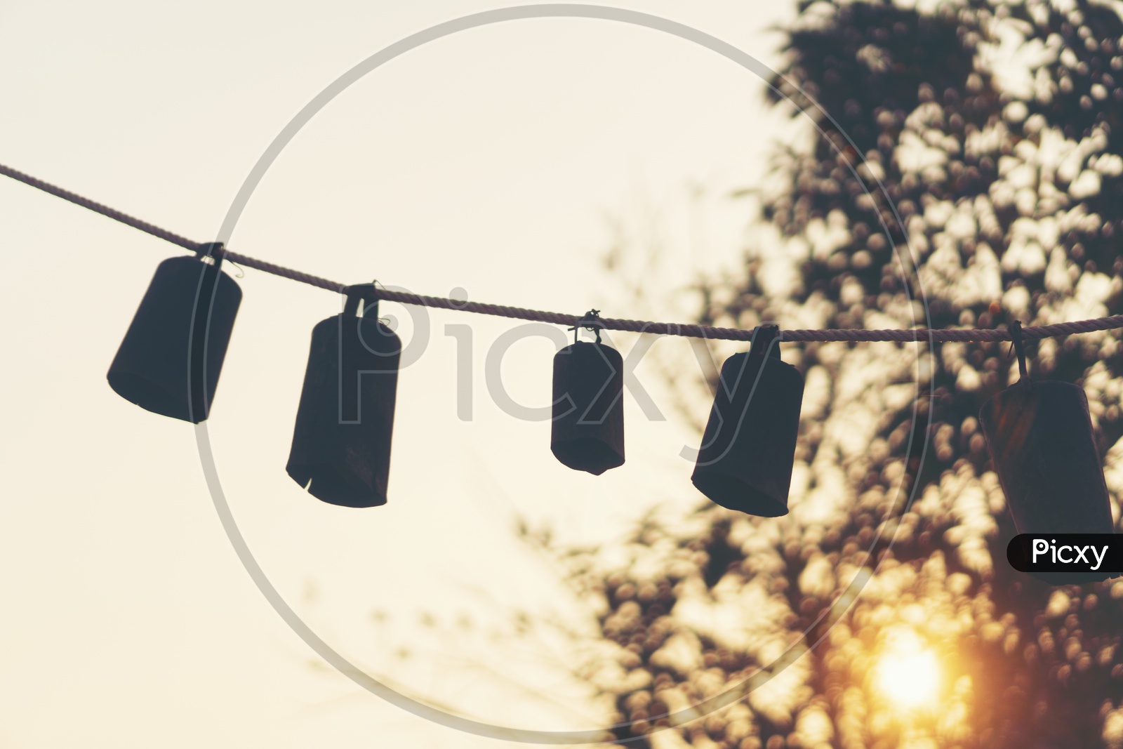 Bells Tagged To Rope With Sunset Luminous Light