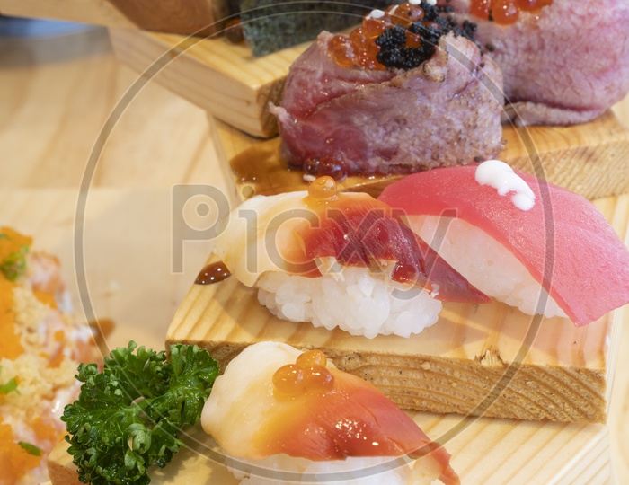 Japanese Cuisine, Fresh Sushi Set Sashimi and sushi rolls on Wooden Background