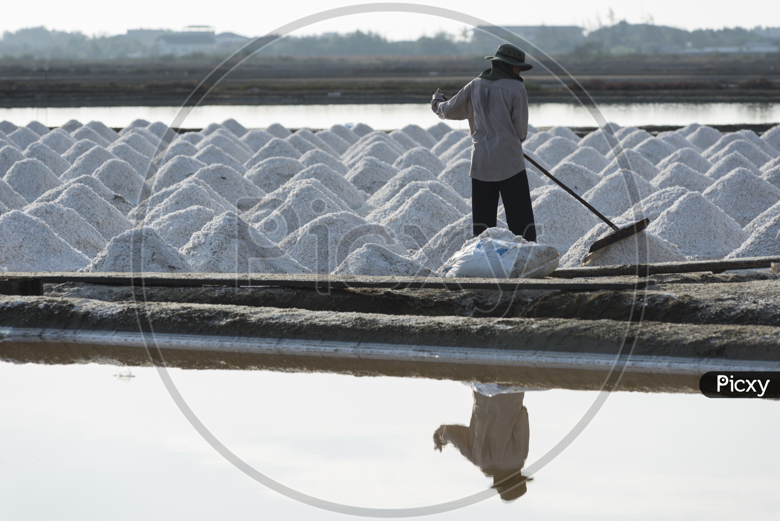 Workers are helping to transport salt from salt field. Ban Laem, Phetchaburi, Thailand