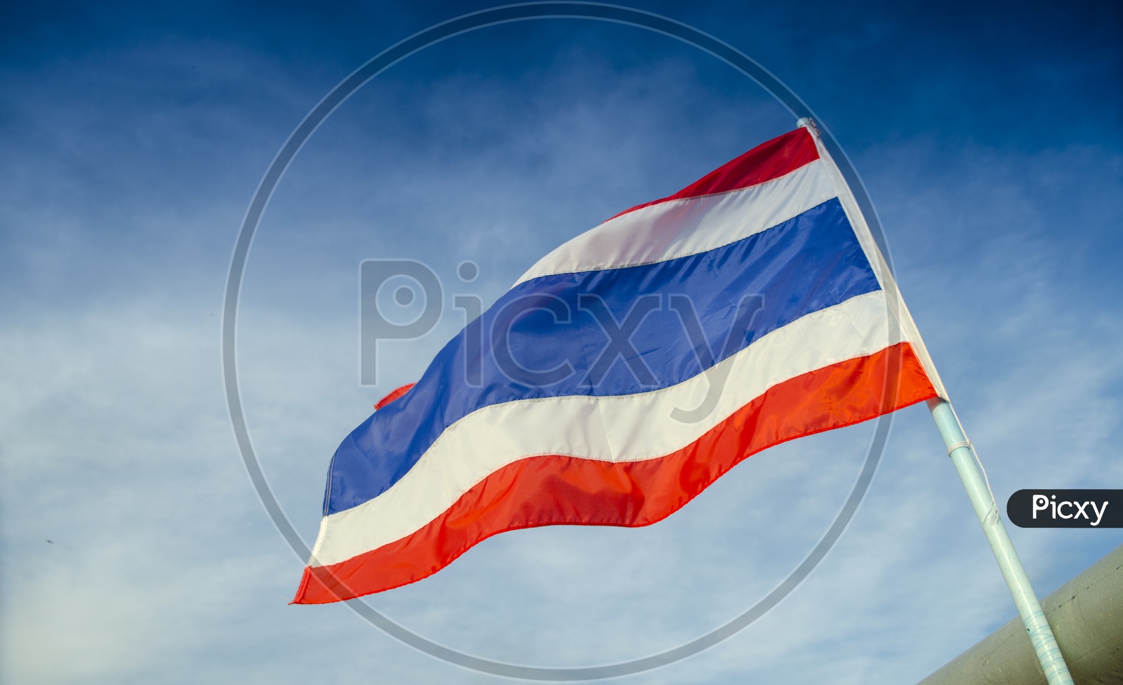 Thai Flag Waving  On Flag Pole With  Blue Sky Background