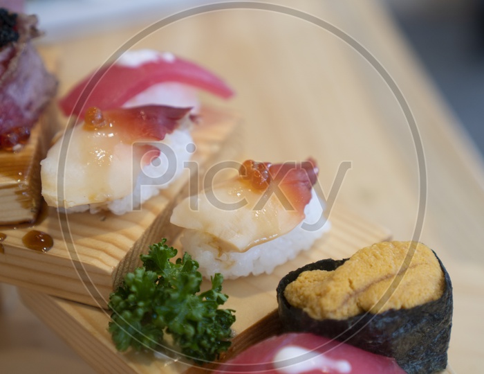 Japanese Cuisine, Fresh Sushi Sashimi on Wooden Background