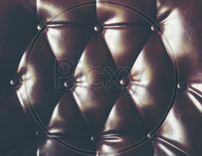 dark leather texture background with buttoned pattern