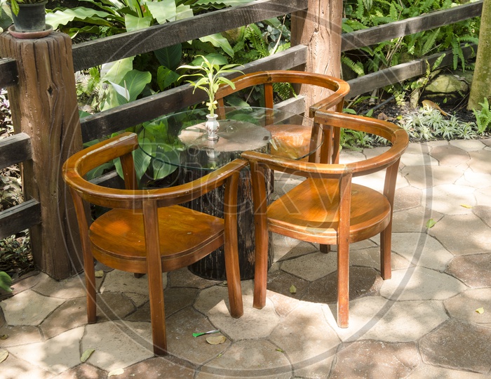 Wooden Chairs Set In Outdoor Garden
