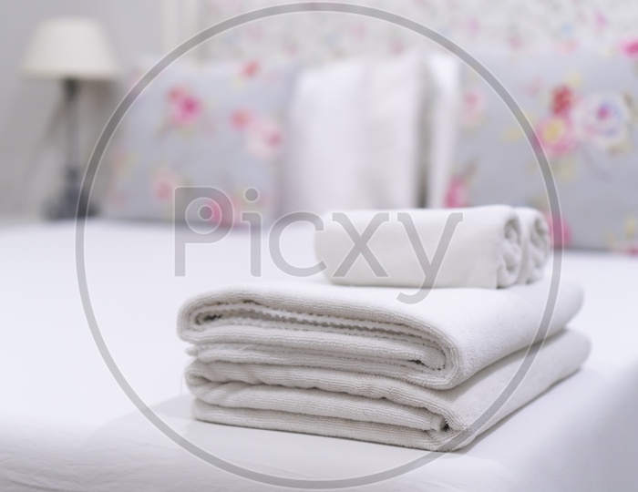 Hotel bedroom With Towels , Cushions And Bath towels