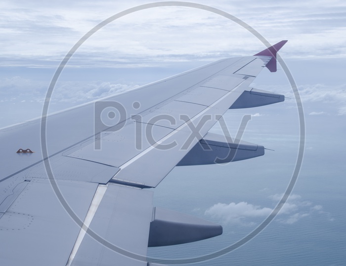 Airplane wing in the blue sky with white clouds Views From  Flight Windows