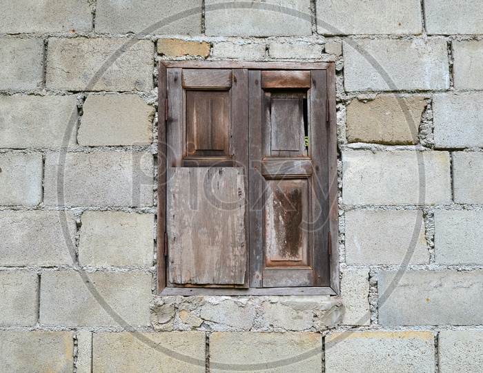 Traditional Wooden Window Over a Stone Wall