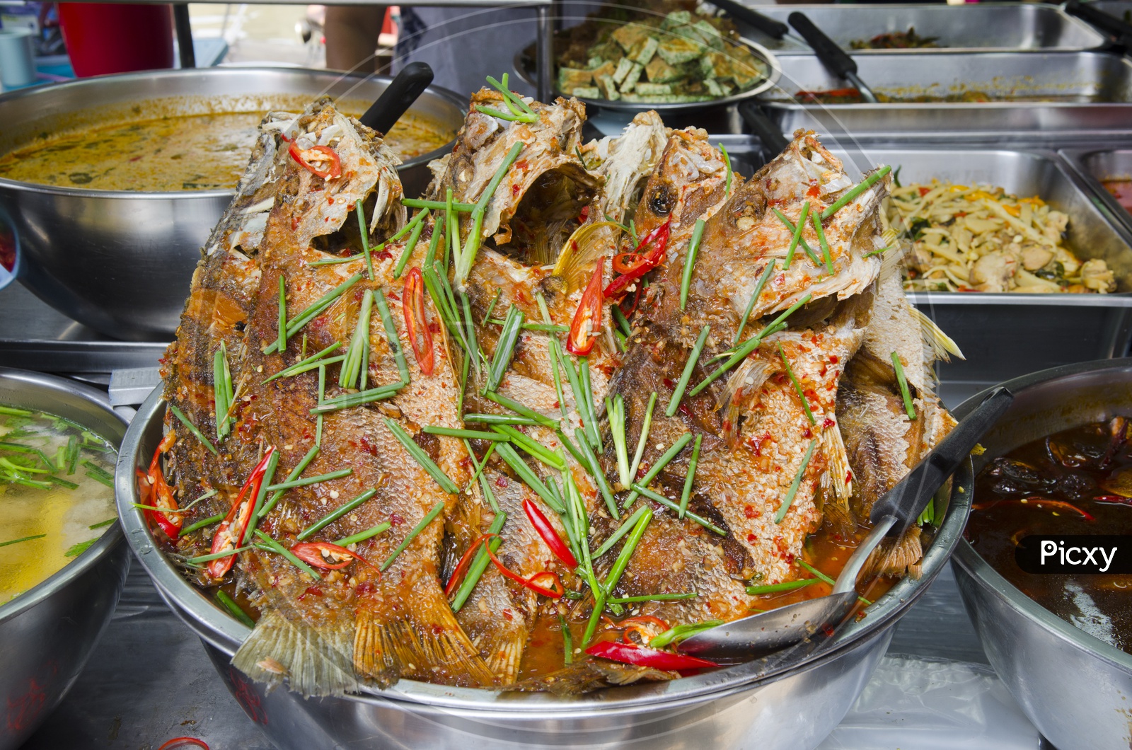 Freshly prepared Thai style whole fish red snapper dinner with tamarind sauce In a Traditional Thai Restaurant