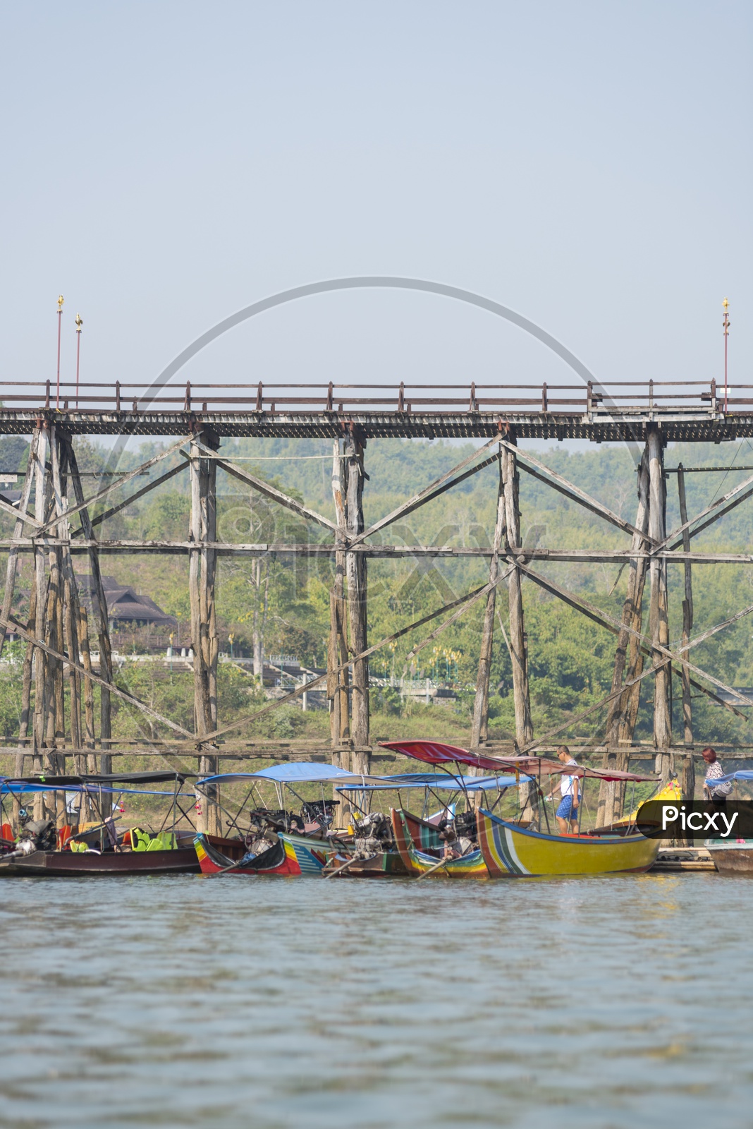 Tourists boats At Mon wooden bridge in background at Sangklaburi, Thailand