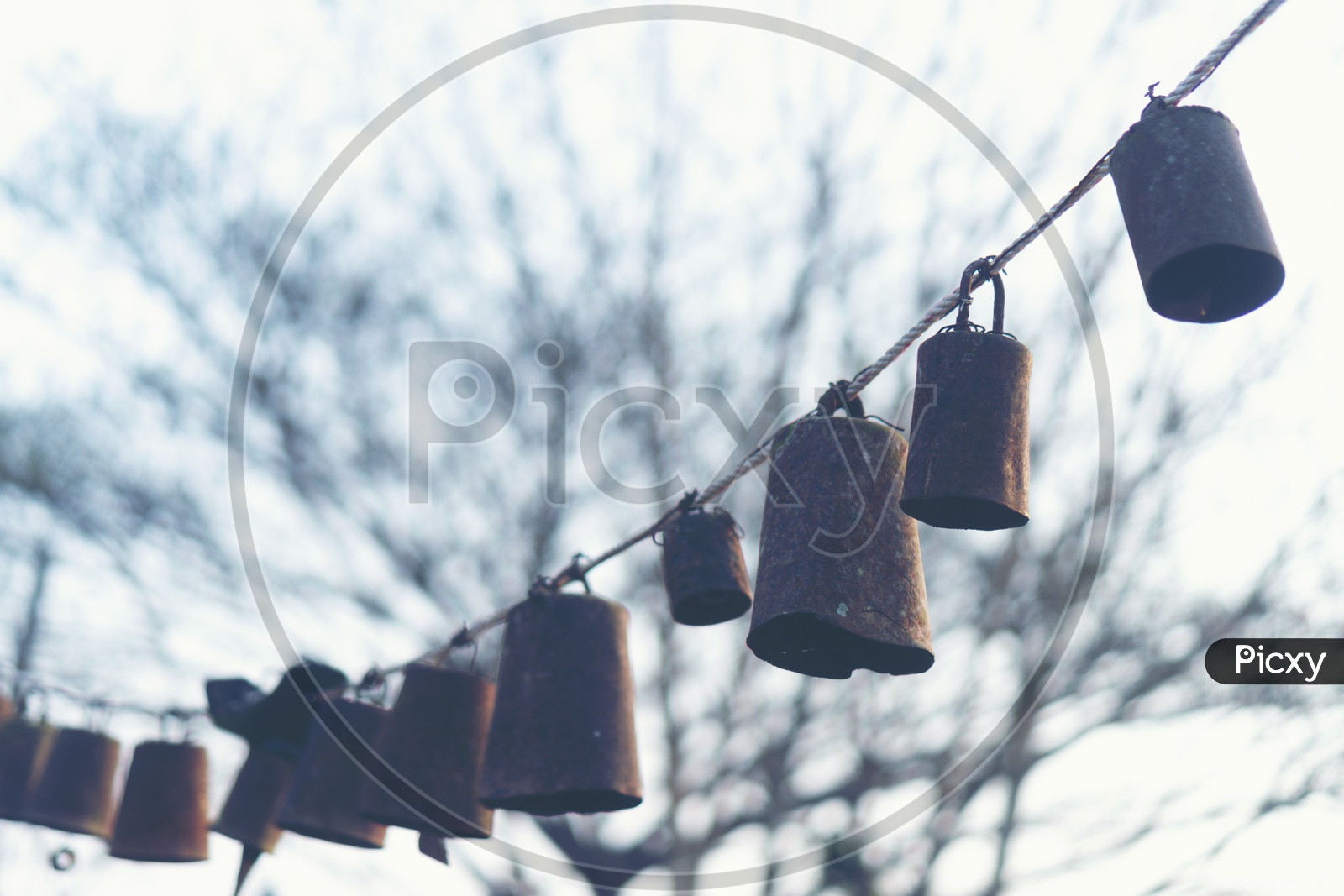 Bells Tagged To Rope With Sunset Luminous Light