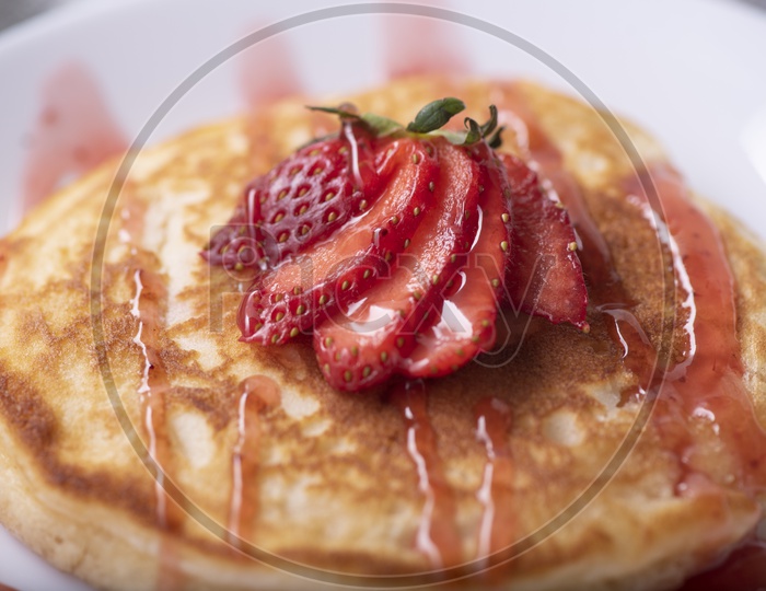 Homemade Pancake with Strawberry and Honey in a Plate
