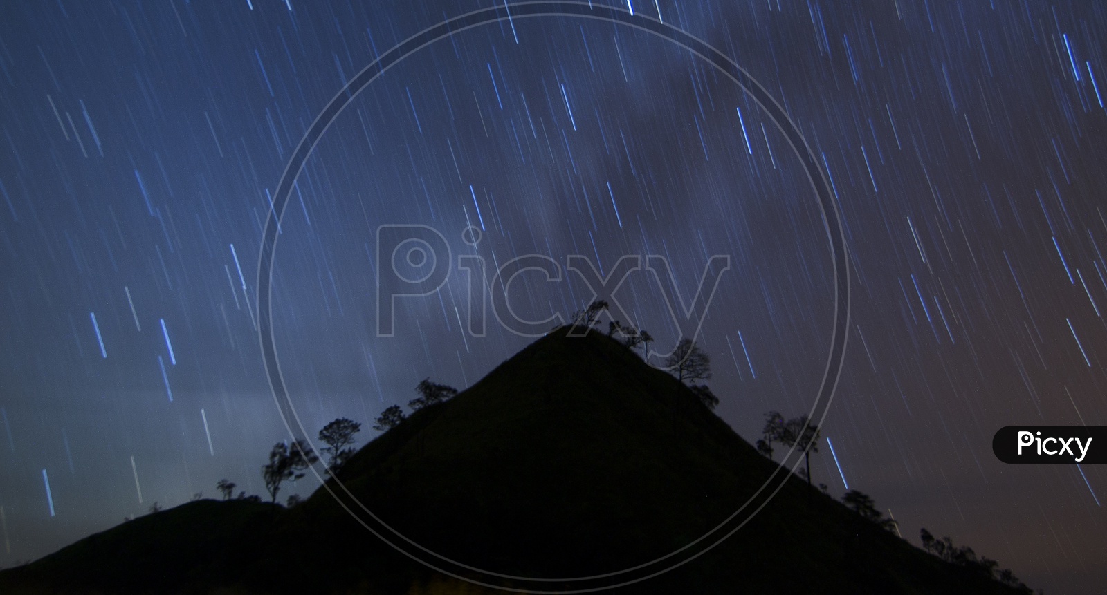 Star Trails With Galaxy or Milkyway Stars  over Mountain in  Khao chang puak, Thailand
