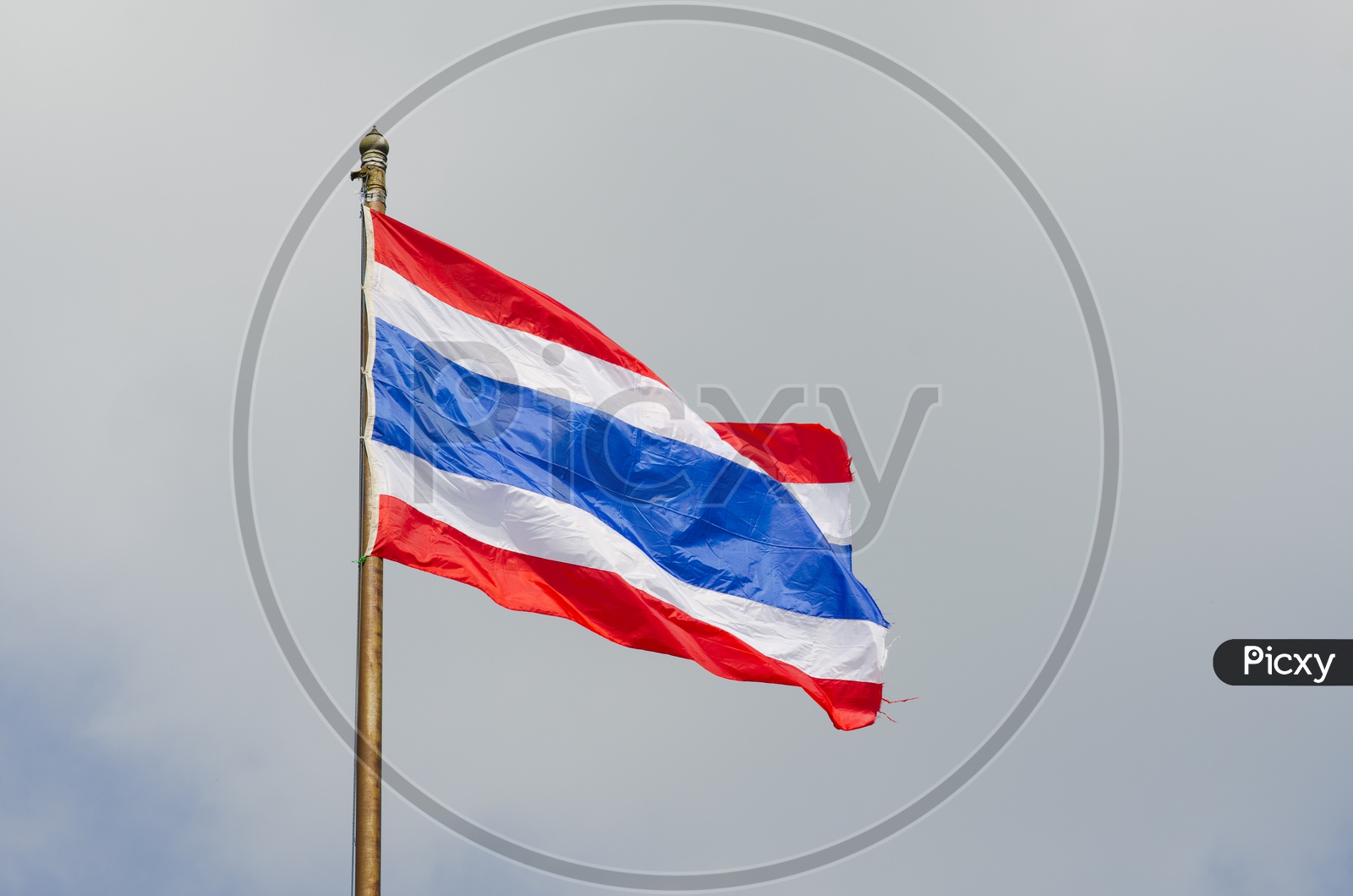 Thai Flag Waving On a Flag Pole Over Sky Background