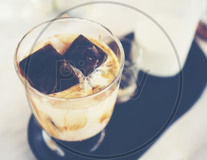 Ice Coffee With Milk and Ice cubes At a Cafe